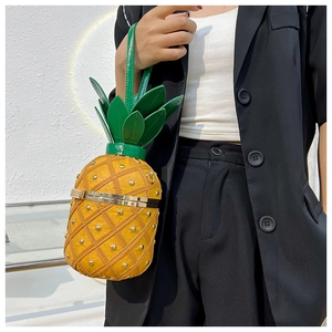 Detailed view of creative pineapple shoulder bag with yellow PU leather and gold studs