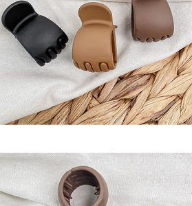 Detailed views of small matte hair claw clips in black, light brown, and dark brown colors
