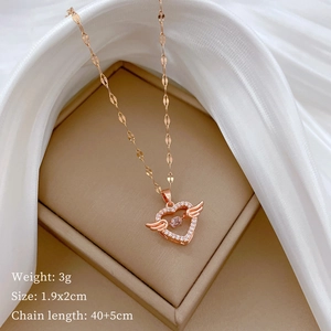 Macro shot of rose gold angel heart pendant with sparkling stones and size details