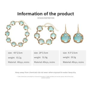 Detailed set of blue resin necklace, bracelet and earrings with golden leaf design