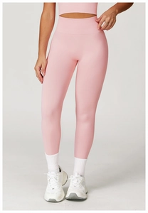 Close-up of high-waist pink yoga leggings featuring ribbed waistband and seamless texture