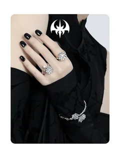 Detailed shot of silver flower rings and bracelet with pearls on a female model