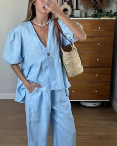 Light blue linen two-piece set featuring a V-neck puff sleeve top and wide-leg trousers