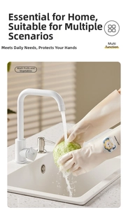 Close-up of white rubber cleaning gloves with yellow chick logo washing fresh fruit