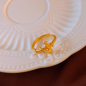 Detailed macro of golden vintage dragon ring with matte scale texture and adjustable open design