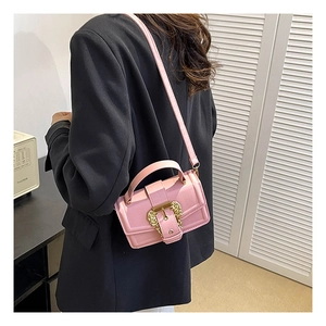 Pink PU leather crossbody bag featuring a golden baroque style buckle and fine texture