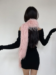 Back view of a model wearing a plush pink faux mink long scarf with a black dress