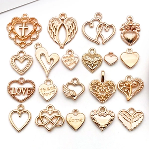 Detailed view of rose gold hollow heart and LOVE charms for DIY jewelry making