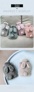 Detail of plush rabbit-shaped hot water bottle covers in multiple pastel colors