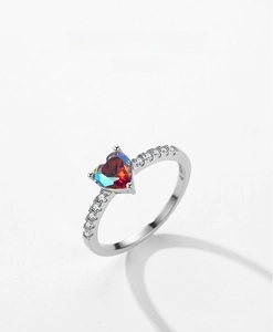 Macro detail of S925 sterling silver ring with heart-cut iridescent aurora gemstone