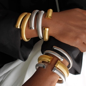 Stackable gold and silver titanium steel open bracelets with textured twisted design