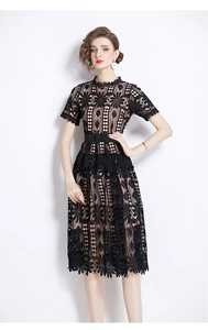 Detail view of the black floral lace texture and intricate hollow embroidery on the dress