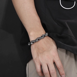 Detail of vintage hand-in-hand engraved titanium steel chain bracelet on wrist