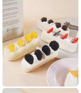Detail shot of long PU artificial cake with cream, strawberries, mango and Oreo topping