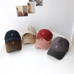 Collection of washed cotton baseball caps with number 7 embroidery in various colors