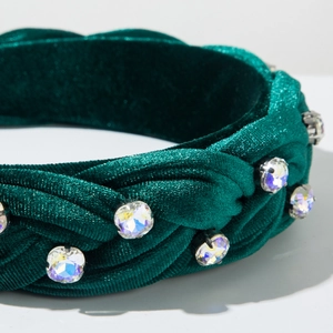 Detail view of emerald velvet braided headband with sparkling large round rhinestones