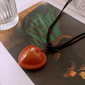 Vintage brown heart faux leather pendant on black woven rope necklace for women