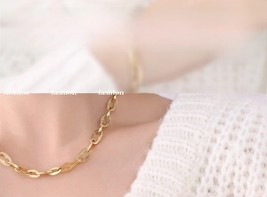 Detail view of 18K gold plated titanium chain necklace with hollow oval link design