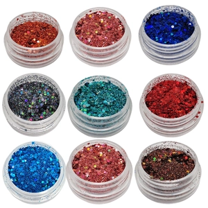 Nine jars of colorful laser nail art glitter powder in 3x3 grid layout on white background