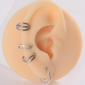 Detailed view of silver titanium double hoop earrings with cubic zirconia on silicone ear
