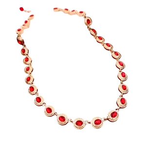 Vintage gold necklace with oval red gemstone cabochons and textured relief design