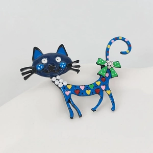 Detail of blue enamel cat brooch with colorful hearts and white pearl necklace detail