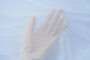 Detailed close-up showing the breathable white mesh fabric texture and transparency