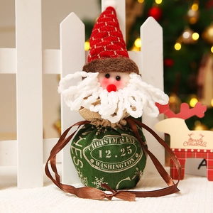 Santa Claus themed Christmas gift bag with drawstring closure in a warm holiday setting