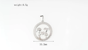 Detail showing an 8.5g iced-out couple pendant with 33.2mm diameter and diamond accents
