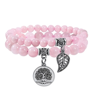 Pink crystal bead bracelet set with silver tree of life and leaf pendants on white background