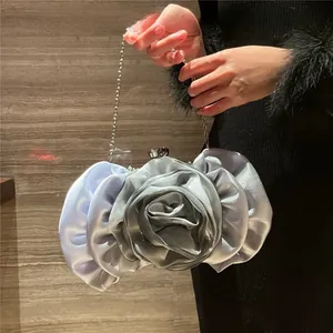 Close-up of silver satin rose evening bag showing petal pleats and metal chain