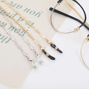 Detail of cross-link glasses chain with silicone loops and lobster clasp in gold and silver