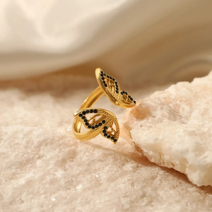 Adjustable golden butterfly ring with black diamond inlay on a white stone base