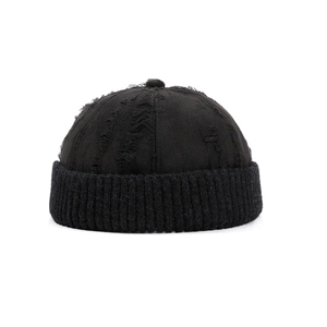 Distressed black vintage docker hat with ripped details and thick ribbed knit brim