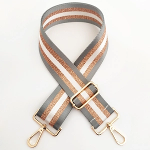 Close-up of 5cm woven bag strap with gold glitter stripes and metallic hardware