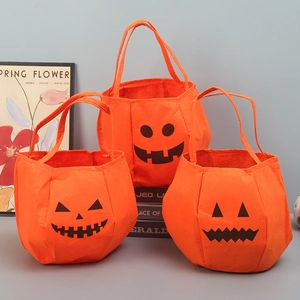 Three different orange Halloween pumpkin felt bags with unique facial expressions and handles
