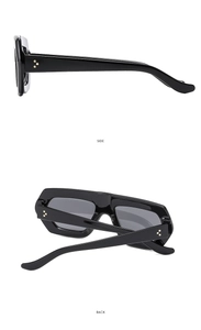 Detail view of black thick frame sunglasses with golden triple dot rivets on side and back