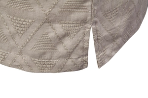 Detail of khaki geometric jacquard fabric and side slit hem on men's short sleeve shirt