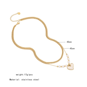 Double-layered gold stainless steel necklace with white heart pendant and pearl accents
