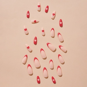 Long ballet press-on nails with French red tips and elegant heart patterns on beige back