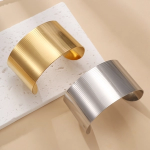Minimalist wide open cuff bracelet in 18k gold and silver with brushed metal texture