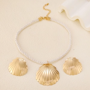 Golden seashell jewelry set featuring a scallop pendant necklace and matching stud earrings