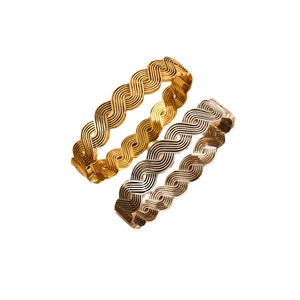 Cross-over wave pattern bangle in 18K gold and silver finishes on white background