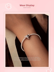 Close-up of s925 silver snake chain bracelet featuring a cute axolotl animal charm