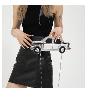 Close-up of a silver vintage car shaped crossbody bag with classic checkered patterns