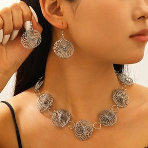 Silver geometric spiral jewelry set with necklace and earrings on model