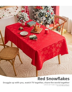 Close-up of red Christmas tablecloth with snowflake patterns in a cozy festive setting