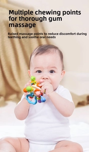 Close-up of baby chewing on colorful sensory teether ball with massage textures