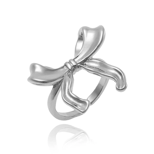 Detailed view of a silver bow-shaped ring featuring a polished metallic finish on white back