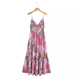 Women's tie-dye floral slip dress with back cutout and tiered skirt on wooden hanger